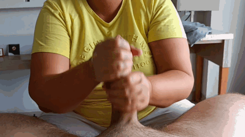 Pornmom in yellow shirt using both hands on huge cock